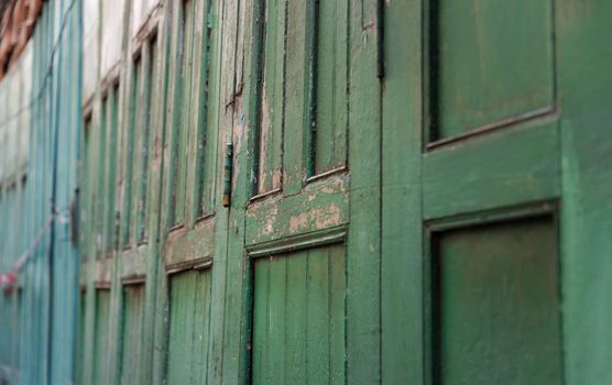 Green vintage wooden door old ancient traditional of home asia. Retro architecture exterior building. Selective focus.