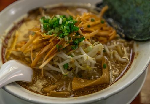 Japanese soup ramen served with chashu pork, Japanese bamboo shoots and sauteed bean sprouts, japanese leek sprinkled with thai spring onions. Japanese food style, Selective focus.