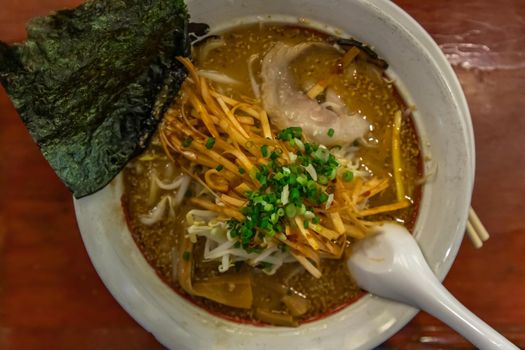 Japanese soup ramen served with chashu pork, Japanese bamboo shoots and sauteed bean sprouts, japanese leek sprinkled with thai spring onions. Japanese food style, Selective focus.