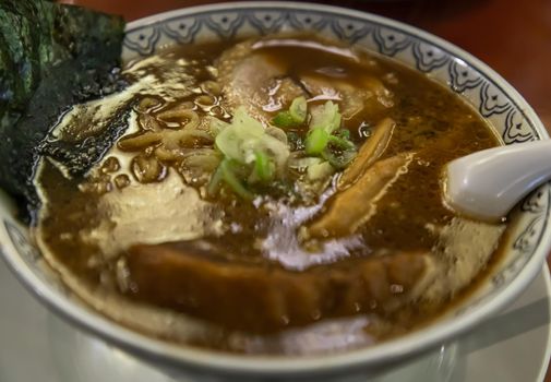 Close-up of Japanese ramen soup served with chashu pork Japanese bamboo shoots Sliced ​​seaweed and scallions. Japanese food style, Selective focus.