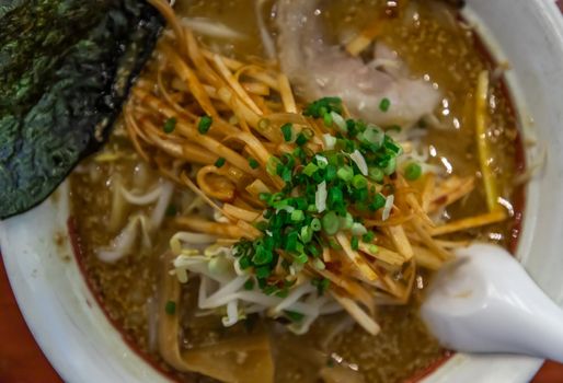 Japanese soup ramen served with chashu pork, Japanese bamboo shoots and sauteed bean sprouts, japanese leek sprinkled with thai spring onions. Japanese food style, Selective focus.