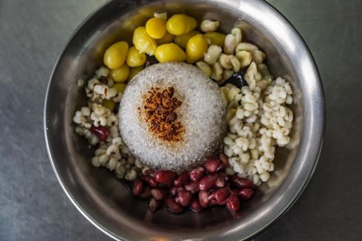 Grass Jelly and cold red beans, ginkgo, millet served with ice in Silver bowl. Thai dessert, Very popular street food in Thailand. Top view. Selective focus.