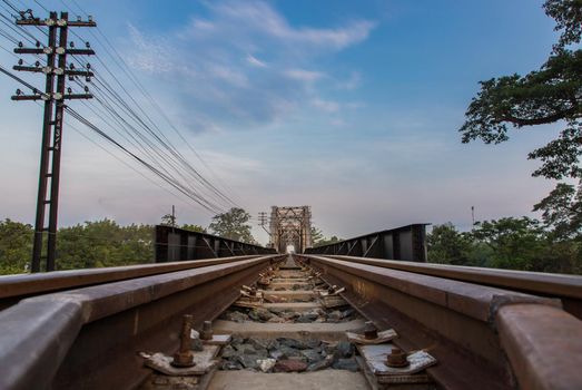 Old railroad tracks on Black Bridge or Lampang Railway Bridge. Railway bridge on river at Lampang thailand. No focus, specifically.
