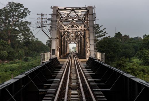 Old railroad tracks on Black Bridge or Lampang Railway Bridge. Railway bridge on river at Lampang thailand. Selective focus.