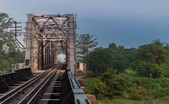 Old railroad tracks on Black Bridge or Lampang Railway Bridge. Railway bridge on river at Lampang thailand. No focus, specifically.