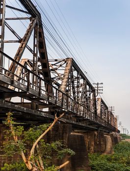 Old railroad tracks on Black Bridge or Lampang Railway Bridge. Railway bridge on river at Lampang thailand. No focus, specifically.