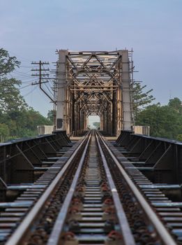 Old railroad tracks on Black Bridge or Lampang Railway Bridge. Railway bridge on river at Lampang thailand. Selective focus.