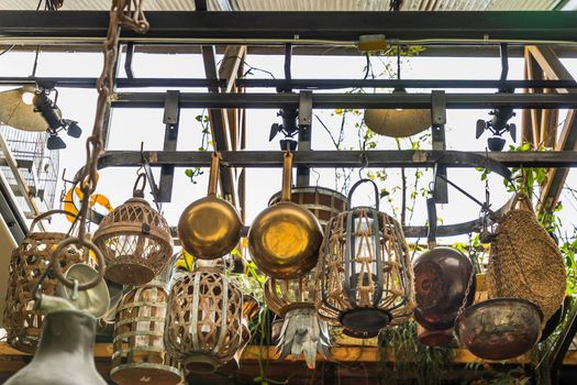 Cooking utensils hanging on Iron railings in the kitchen. kitchen appliances, No focus, specifically.