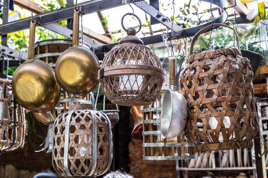 Cooking utensils hanging on Iron railings in the kitchen. kitchen appliances, No focus, specifically.