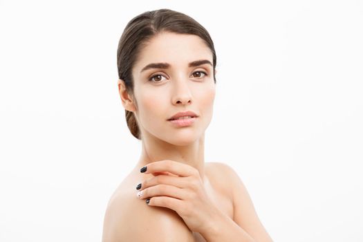 Beauty and Skin care concept - Close up Beautiful Young Woman touching her skin on white background