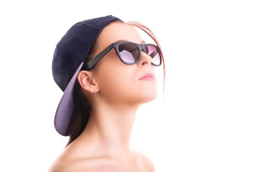 Close up shot of a beautiful stylish girl with backwards snapback cap and sunglasses, isolated on white background. Cool concept.