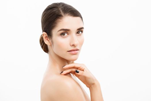 Beauty and Skin care concept - Close up Beautiful Young Woman touching her skin on white background