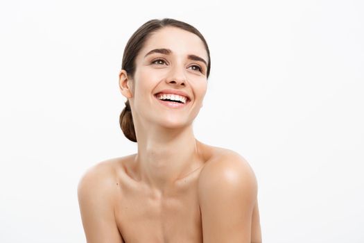 Health care and spa concept - attractive young and healthy woman with nude makeup on white background