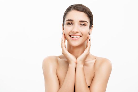 Beauty and Skin care concept - Close up Beautiful Young Woman touching her skin on white background