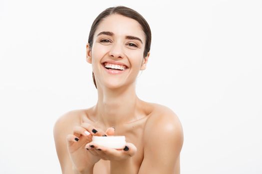 Beauty Youth Skin Care Concept - Beautiful Caucasian Woman Face Portrait smiling and holding cream jar for body and skin.Isolated over white background