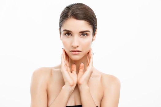 Beauty and Skin care concept - Close up Beautiful Young Woman touching her skin on white background