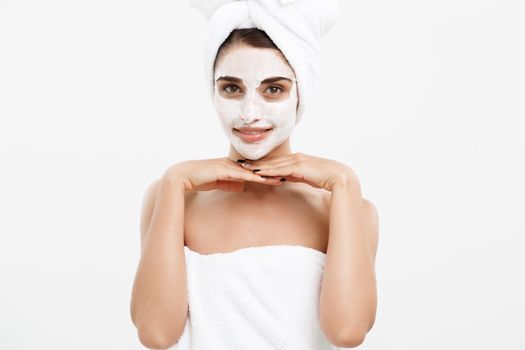 Beauty Skin Care Concept - Beautiful Caucasian Woman Face Portrait applying cream mask on her facial skin white background