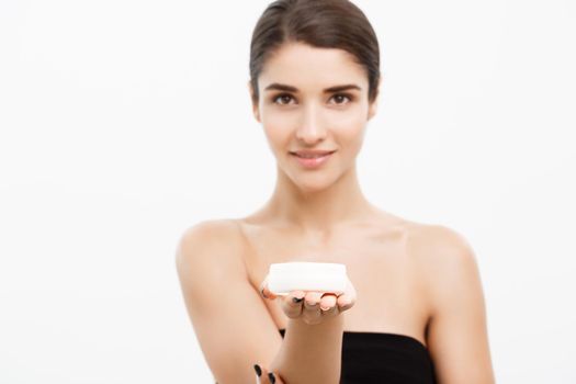 Beauty Youth Skin Care Concept - Beautiful Caucasian Woman Face Portrait smiling and holding cream jar for body and skin.Isolated over white background