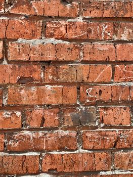 Old red brick wall. The bricks are laid in rows. Grunge stone texture. High quality photo