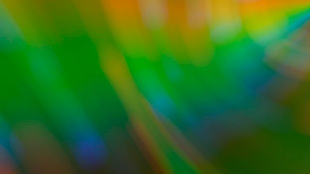 Abstract blurry green background with rainbow highlights.