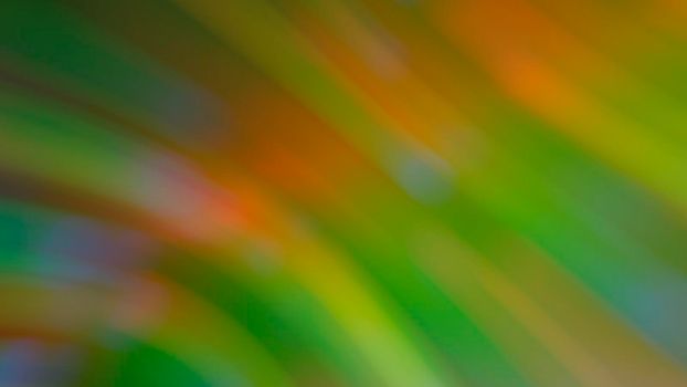 Abstract blurry green background with rainbow highlights.