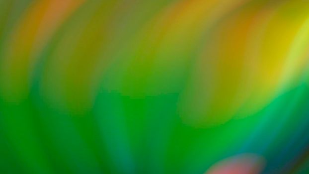 Abstract blurry green background with rainbow highlights.