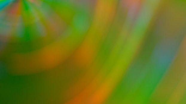 Abstract blurry green background with rainbow highlights.