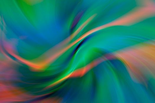 Abstract blurry green background with rainbow highlights.