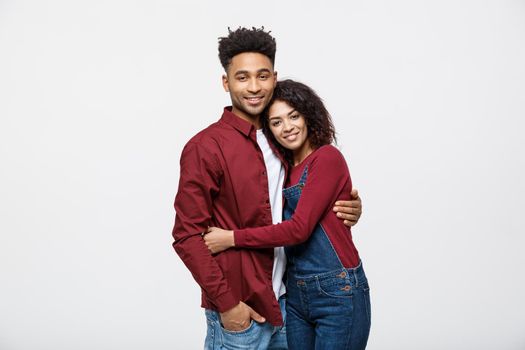 portrait of happy african american couple hug each other on white background