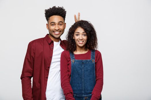 Happy young African couple dressed casually having fun together