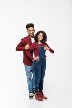 Lovely African American couple gesturing thumbs up to camera