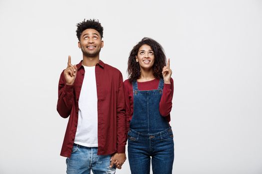 Young African American people in casual clothes looking away and point finger. isolated on white background.