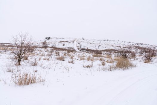 snow-covered hill mountain against a white sky. High quality photo