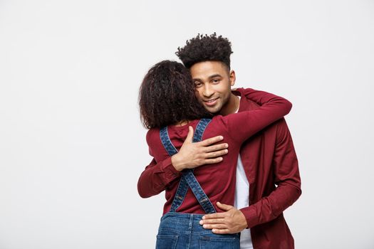 portrait of happy african american couple hug each other on white background