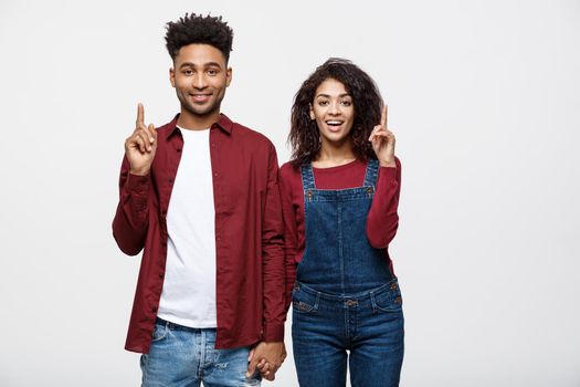 Young African American people in casual clothes looking away and point finger. isolated on white background.