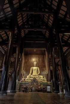 Chiangmai, Thailand - Sep 07, 2020 : The buddha image in main vihan at wat phun tao. Wat phan tao is a beautiful wooden temple in chiang mai. Selective focus.