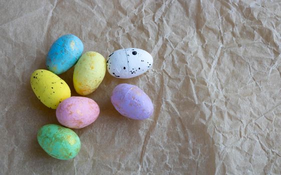 Colorful Easter eggs lie on crumpled paper.Easter Concept. Space for your text.