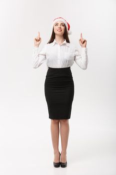 Business Concept - Modern caucasian business woman in the white studio background pointing finger upward presenting product.