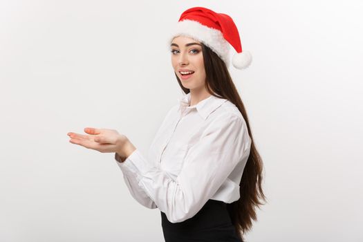 Business Concept - Modern caucasian business woman in the white studio background holding hand onside presenting product.