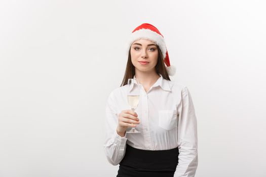 Christmas Celebration - Young beautiful business woman celebrating christmas with glass of champagne.