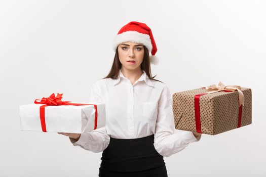 Christmas Concept - young happy caucasian business woman with santa hat choosing gift boxs with copy space on side.
