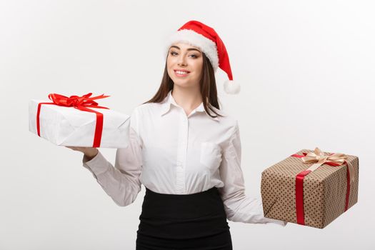 Christmas Concept - young happy caucasian business woman with santa hat choosing gift boxs with copy space on side.