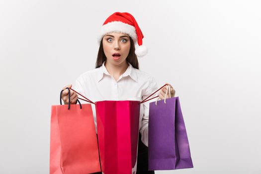 Christmas Concept - beautiful caucasian business woman shocking with gift inside shopping bag.