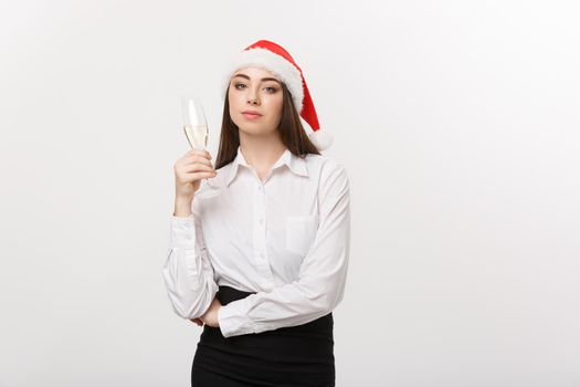 Christmas Celebration - Young beautiful business woman celebrating christmas with glass of champagne.