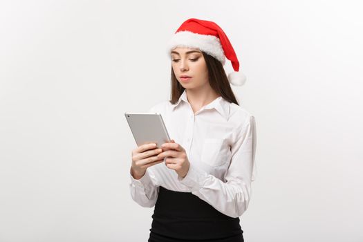 Business Concept - young business woman woking on digital tablet in Christmas day.