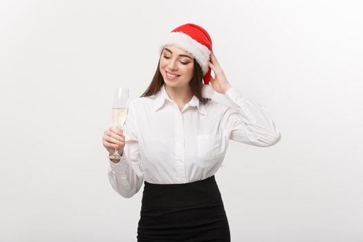 Christmas Celebration - Young beautiful business woman celebrating christmas with glass of champagne.