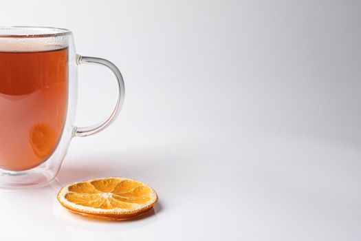glass thermo mug with black tea on a white background. High quality photo