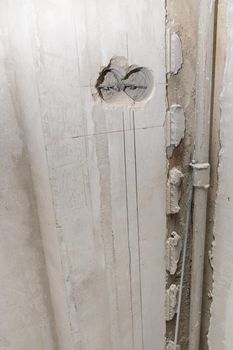 Holes in the wall for sockets. Electrical wiring in the wall. Repair, marking of sockets