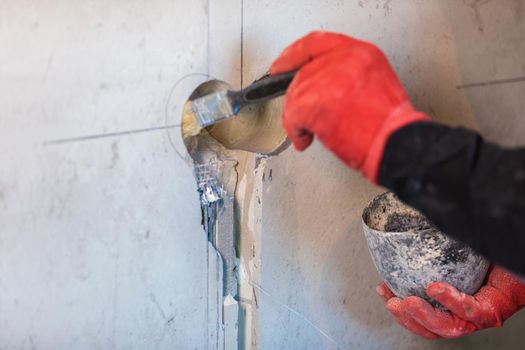 The electrician will prime the holes and channels for outlets and wires. Repair of apartments. Close-up