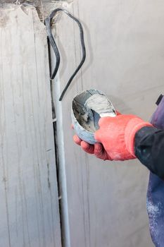 The electrician will plaster holes and channels for sockets and wires. Repair of apartments. Close-up
